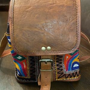 Handcrafted leather and embroidered crossbody bag with adjusted strap
